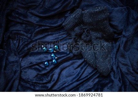 Christmas decoration on royal blue background. Top view on stars, wings and ornaments. 