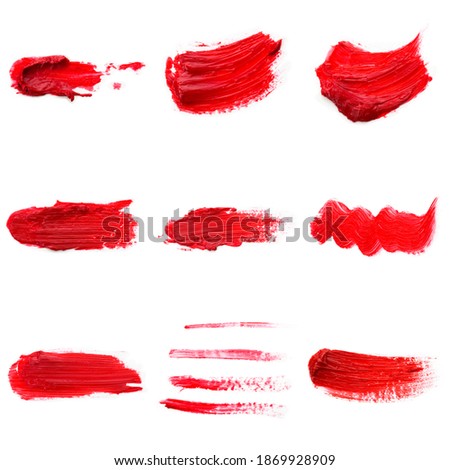 Lipstick smear smudge swatch isolated on white background. Cream makeup texture. Bright red color cosmetic product brush stroke swipe sample