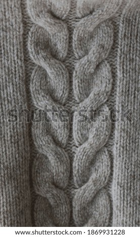 Beautiful beige knitted sweater close up view