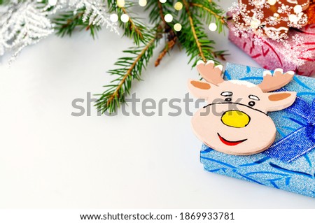 Toy elk moose on a blue gift box. Animation for a happy New year greeting card. Christmas card. Background for the text