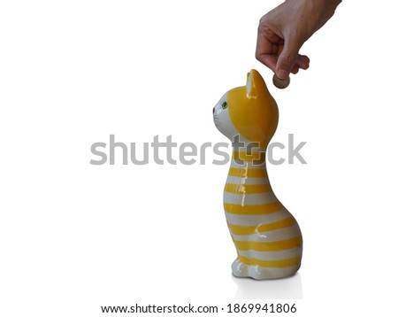  Put a five-baht coin into a white and yellow cat-shaped piggy bank, on white background, object, animal, copy space                             