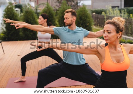Stretching 35-40s group of people before work out outdoors