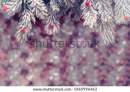 Christmas card with frosty fir-tree branches over holidays lights