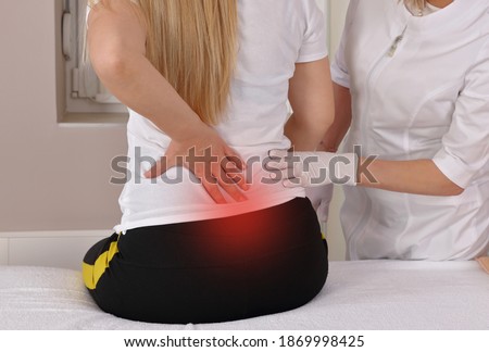 Pregnant woman With Back Low Ache Visiting Doctor's Office. Chiropractic, Osteopathy, Physiotherapy concept