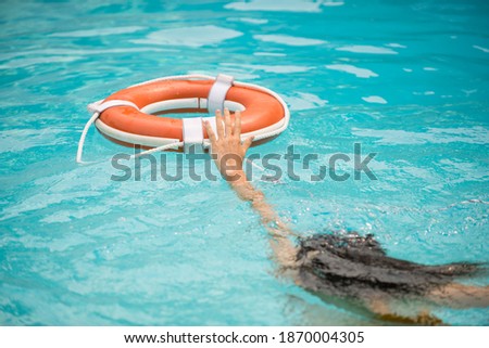 Life buoy, concept of help, rescue. Lifebuoy in water. Life ring floating in a sea, life preserver. Rescue ring. Rescuering, Safety ring in blue water Royalty-Free Stock Photo #1870004305