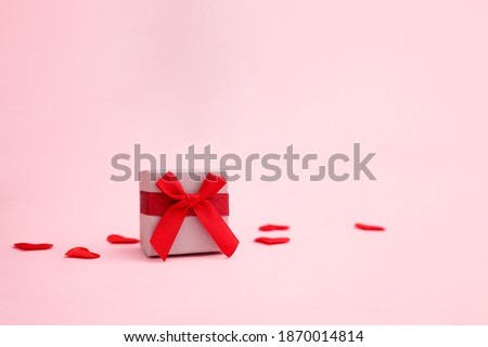 Holiday pink background with gift. Valentine's Day, Happy Women's Day, Mother's Day, Birthday, Wedding greeting card concept. Copy space
