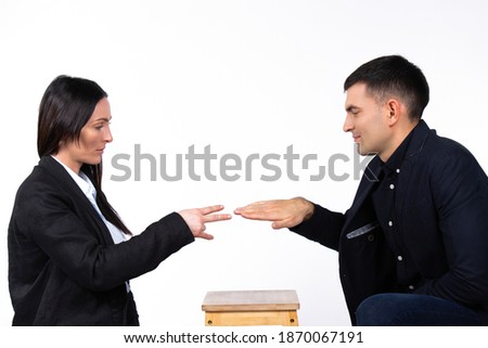 Game battle between a businesswoman and a businessman. The woman wins. Photo on a white background.