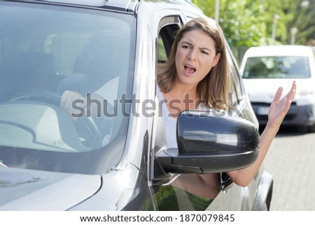 angry female driver shouting out of the window