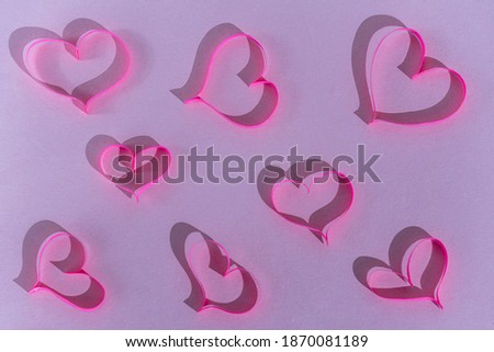 hearts of pink paper on a pink background. valentine's day concept