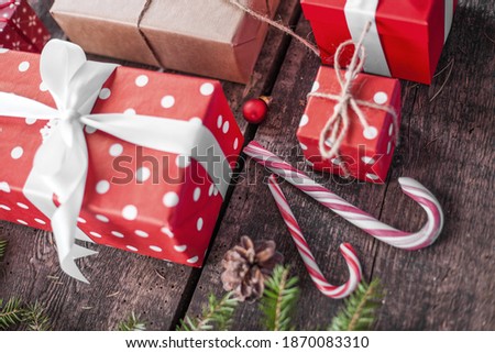 Gift box in wrapping paper with satin ribbon. Merry Christmas holiday concept.