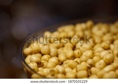 Yellow bean seed in a transparent bowl with blur background