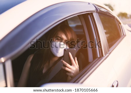 close up picture of woman wearing face mask and sitting on the car in during the ways.