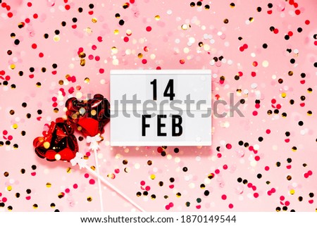 Saint Valentine's day  festive background. Bokeh lights and confetti February 14 . Top horizontal view copyspace. Royalty-Free Stock Photo #1870149544