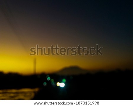 Blurred photo on village road with mountain view  in the morning