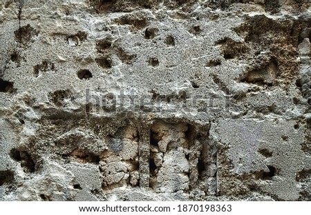 The surface image of cracked gray cement wall building. The abstract cracked cement wall picture for decorative design.