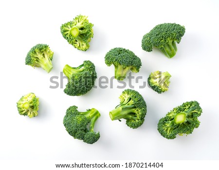 Cut broccoli placed on a white background. View from above Royalty-Free Stock Photo #1870214404