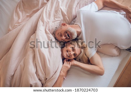 Happy morning. Mature couple resting together and feeling pleased