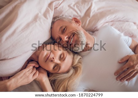 Tenderness. Mature couple having romantic moment in bedroom