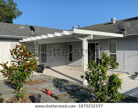 White aluminum patio cover attached to California home.