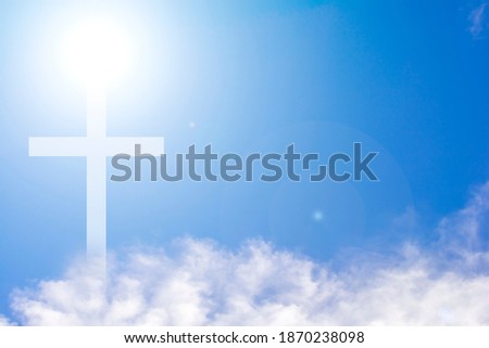 Christian cross  on the clouds and blue sky with shining light. 