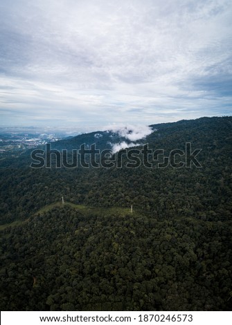 Kuala Lumpur, Malaysia - Aerial view of hills with the present of low clouds and mist captured using drone.
