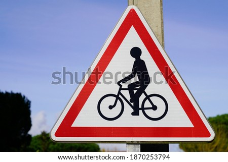Car overtakes cyclist bicycle warning sign road danger