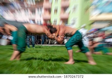 Unidentified wrestlers participate in the annual oil wrestling 