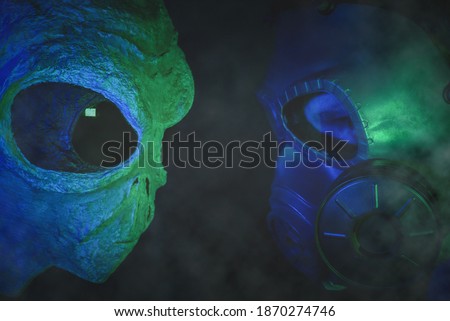 Human vs alien concept. Space confrontation. Soldier in gas mask standing face to face with a humanoid.