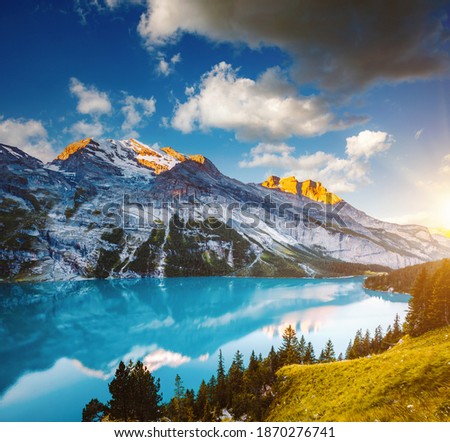 Awesome summer view of the lake Oeschinensee in sunny day. Location Swiss alps, Switzerland, Kandersteg district, Europe. Vivid photo wallpaper. Image of exotic place. Discover the beauty of earth. Royalty-Free Stock Photo #1870276741