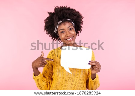 Young and beautiful woman pointing on white speech bubble board. African american girl wears casual outfit . Emotions and pleasant feelings concept.