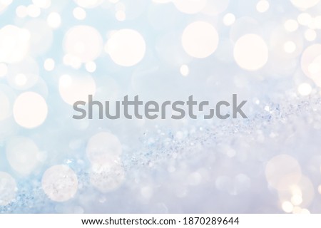 Shiny silver defocused glitter background with golden lights