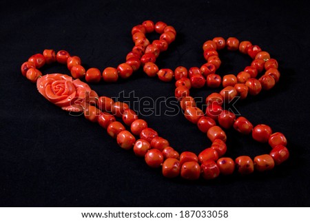Red coral necklace on a black background Royalty-Free Stock Photo #187033058