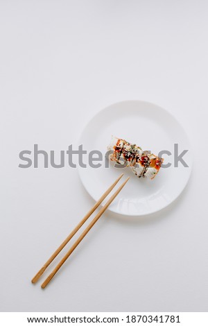 Eel sushi rolls rice sesame seeds and soy sauce. Seductive sushi rolls with eel, avocado and cucumber and Philadelphia cheese. Isolated. Sushi roll on a white background. Royalty-Free Stock Photo #1870341781