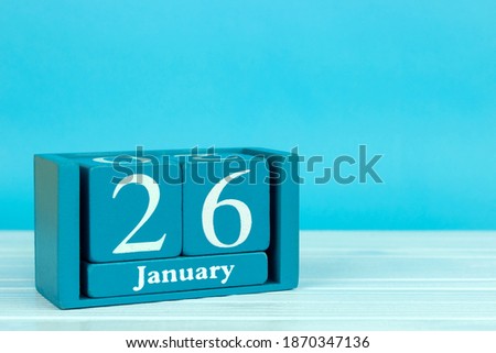 wooden calendar with the date of December 26 on a blue wooden background, International Customs Day