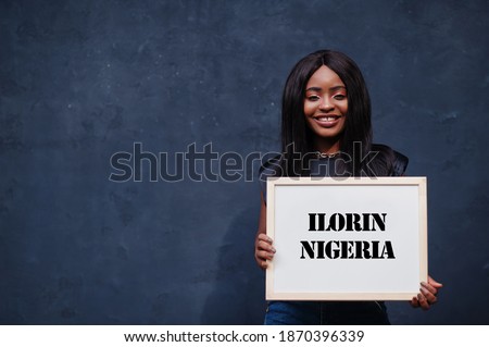 African woman hold white board with Ilorin Nigeria inscription. Most populous city in Africa concept.
