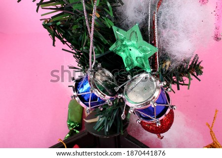 Decorated green Christmas tree with patchwork ornament artificial star hearts isolated on pink background images