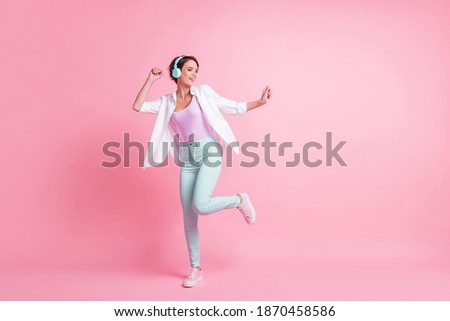 Full body portrait of dancing person make moves earphones unbuttoned shirt isolated on pink color background