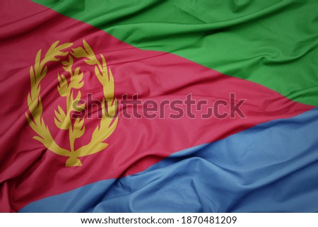 waving colorful national flag of eritrea. macro shot