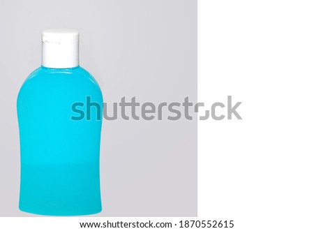 Plastic Sanitizer Container. Room to write. Close up of blue hygiene container on a grey background. Stock Image,