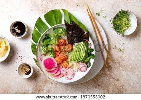 Hawaiian salmon poke bowl with seaweed, avocado, watermelon radish and cucumber. Top view, overhead, flat lay Royalty-Free Stock Photo #1870553002