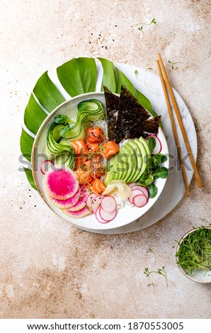Hawaiian salmon poke bowl with seaweed, avocado, watermelon radish and cucumber. Top view, overhead, flat lay Royalty-Free Stock Photo #1870553005