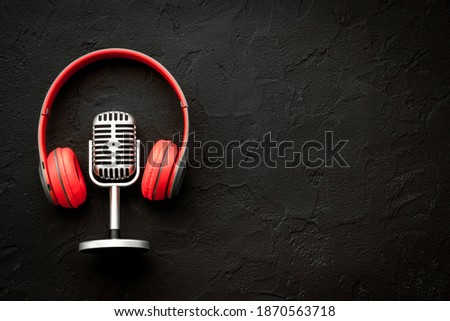 Recording background. Microphone and headphones on table, top view