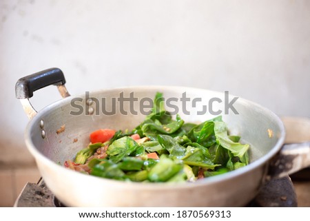 Stainless steel pan on stove in countryside kitchen for cooking, blurred picture. 