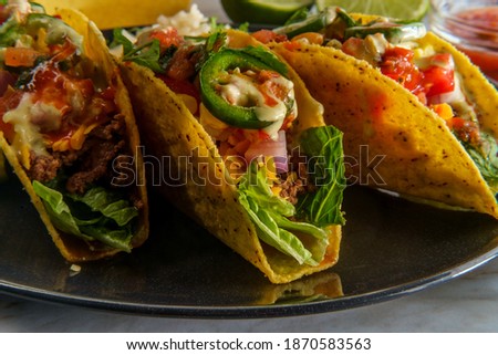 Mexican beef tacos with rice refried beans tortilla chips and various toppings Royalty-Free Stock Photo #1870583563
