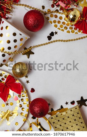New Year 2021festive table decoration, party. Christmas gold stars, festive paper plates and glasses, multicolored hearts, gold confetti stars on white background