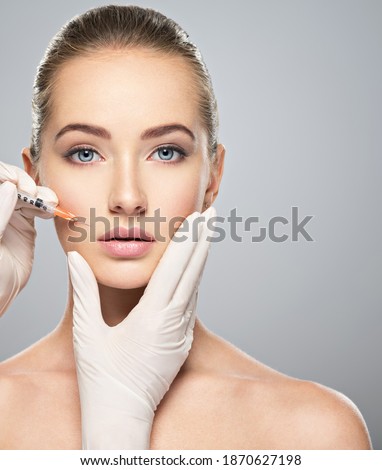 Woman getting cosmetic injection of botox near lips, closeup. Woman in beauty salon. plastic surgery clinic. Royalty-Free Stock Photo #1870627198