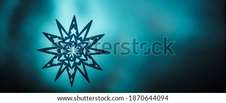 Paper star on the window against a blurred background