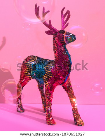 stag with colorful sequins with lots of glitter and floating bubbles around