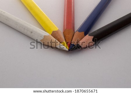 Colored pencils white, yellow, red, blue, black.
