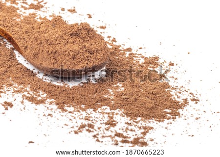 Studio lighting. allspice on a wooden spoon, on a white background. There is a shadow. Close-up. No isolation